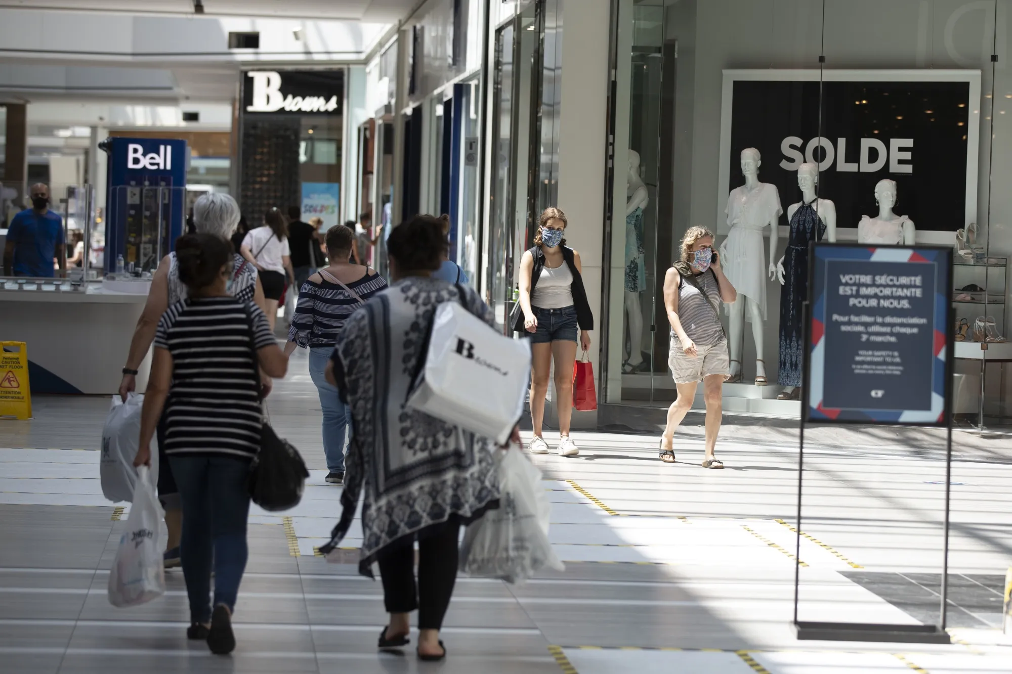 Shoppers wear protective masks at a mall in Montreal, Quebec, Canada, on Saturday, July 18, 2020.