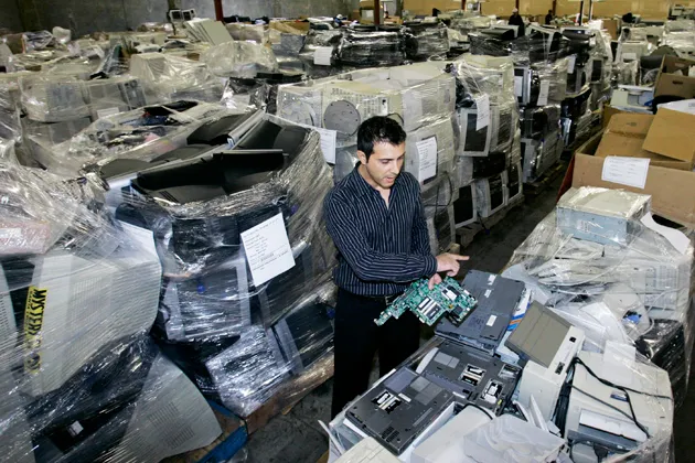 Chief executive officer John Bekiaris sorts through a warehouse filled with discarded computers at HMR USA Inc in Brisbane, California