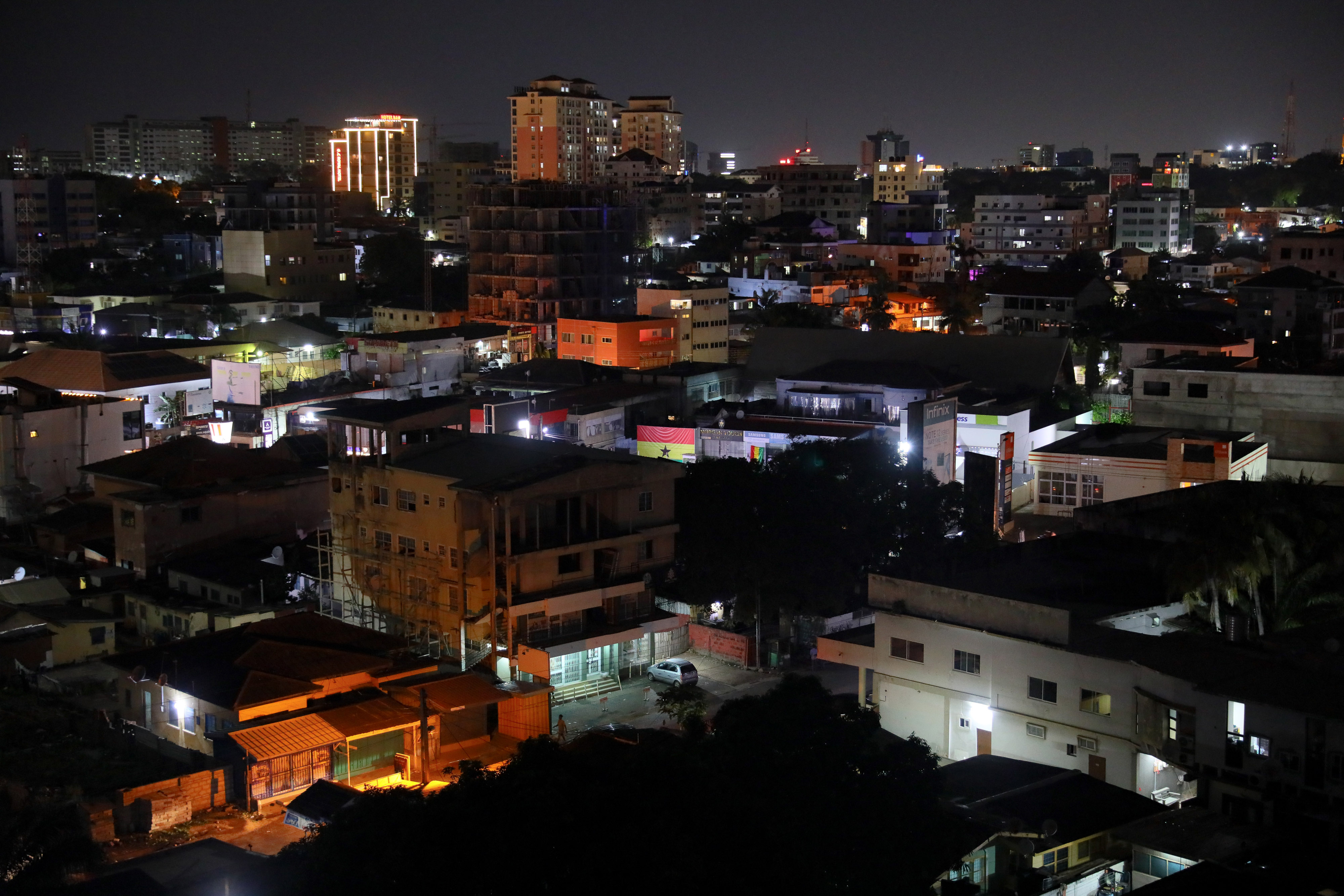 Residential and commercial buildings on the skyline at night in Accra, Ghana, on Sunday, Dec. 4, 2022. With debt interest payments eating up more than half of government revenues Ghana has asked the IMF for a $3 billion bailout, proposed a debt restructuring that could involve losses of up to 30% for foreign investors and is planning to barter some of the gold it produces for oil. Photographer: Nipah Dennis/Bloomberg