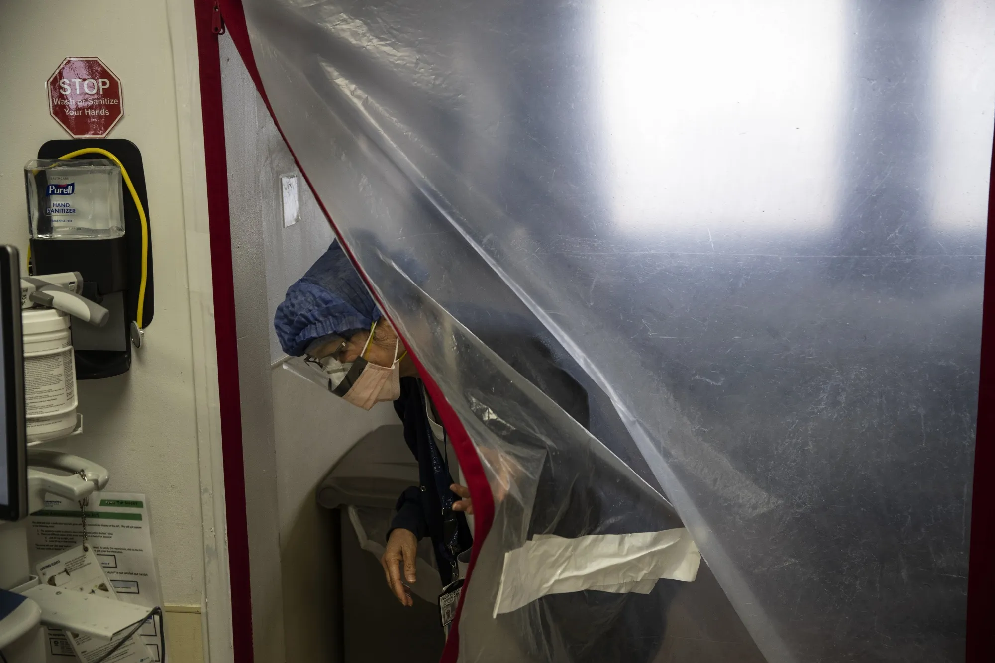 A nurse exits a&nbsp;barrier of a patient's room in the ICU&nbsp;at University Hospital in Newark, New Jersey.