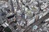 Commercial buildings stand while a train, bottom right, travels along a railway track, seen from the Shibuya Sky observation deck of the Shibuya Scramble Square building in Tokyo, Japan, on Tuesday, Sept. 29, 2020. The Bank of Japan (BOJ) will release its quarterly Tankan business sentiment survey on Oct. 1.