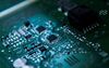 Gold wire bonded chips sit on a circuit board .