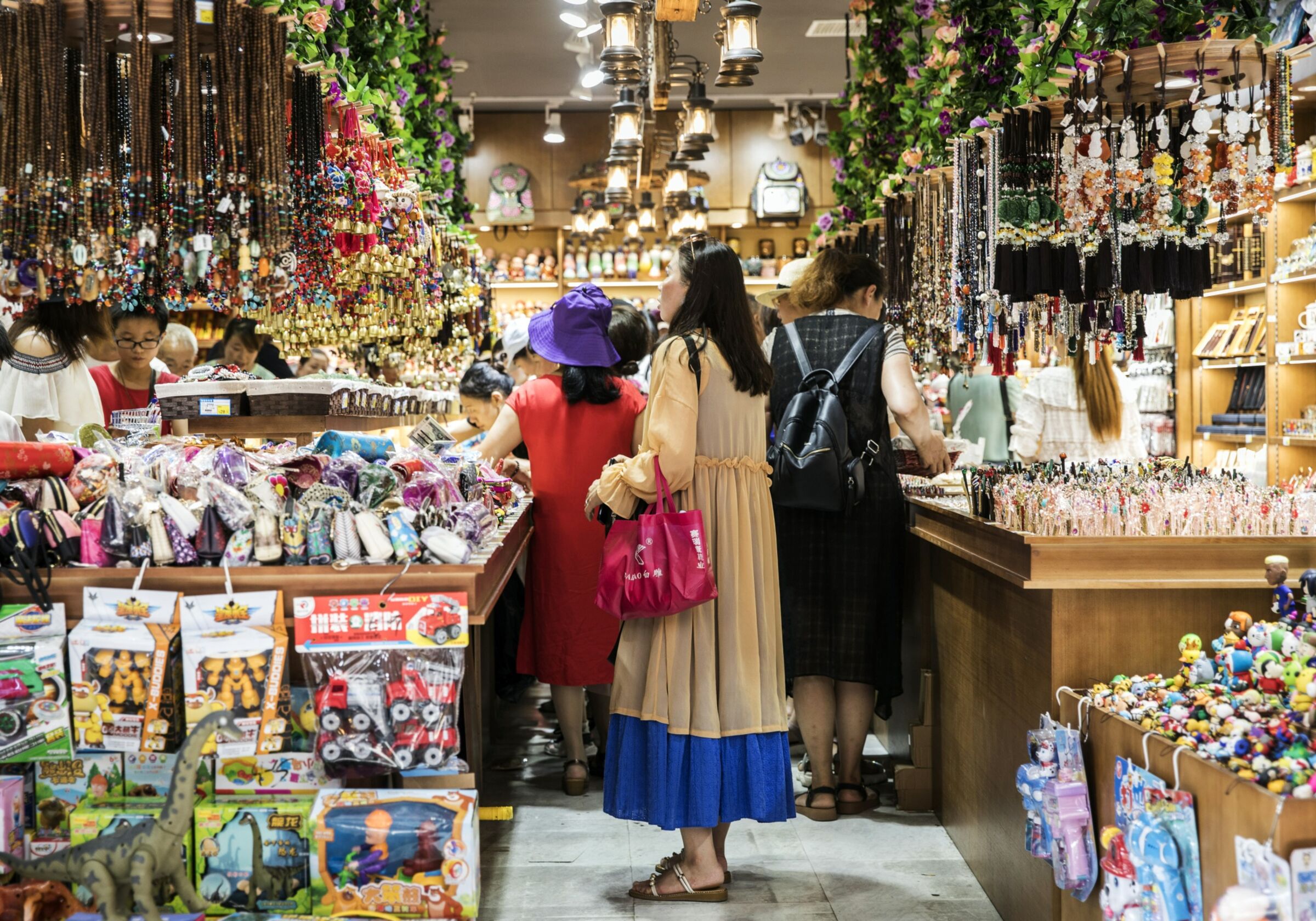 A customer looks at souvenirs on display at a store in the Yuyuan Bazaar district of Shanghai.