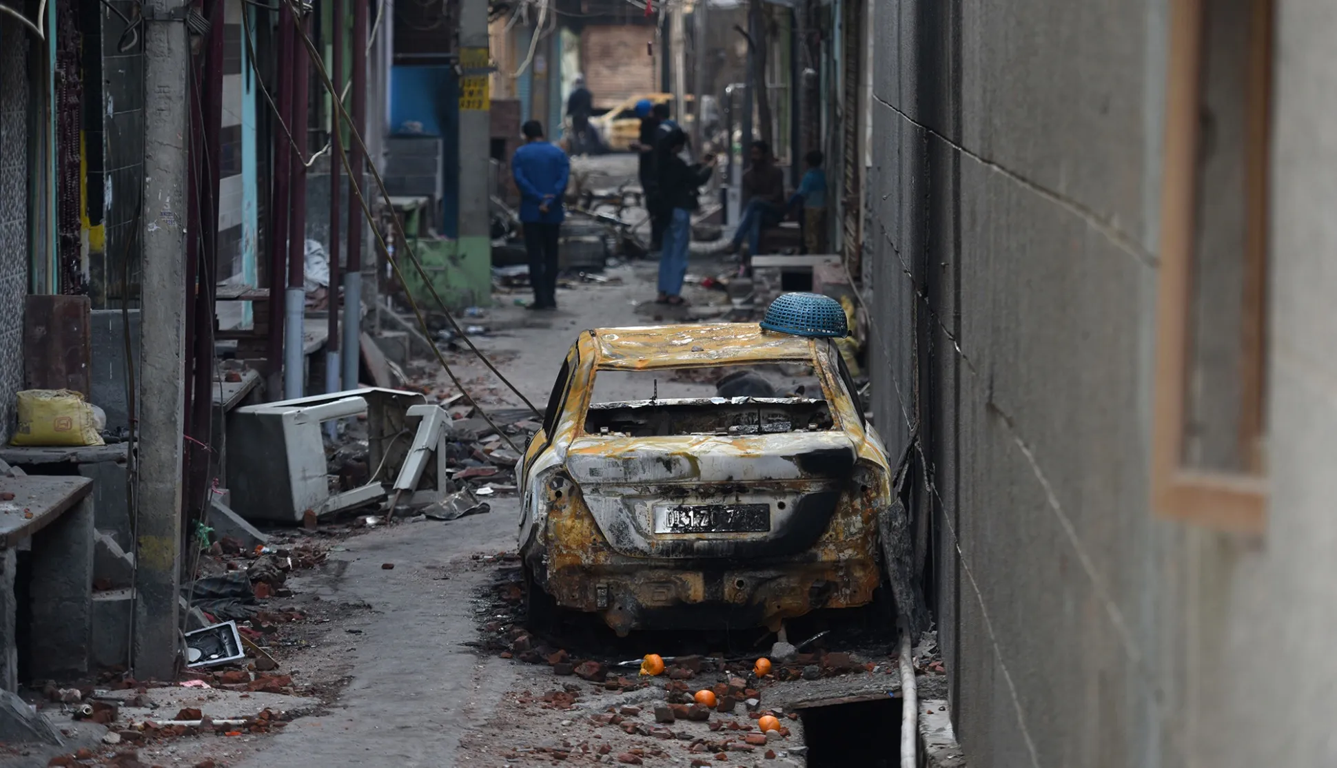 A burnt car and damage after riots in New Delhi, on March 1.