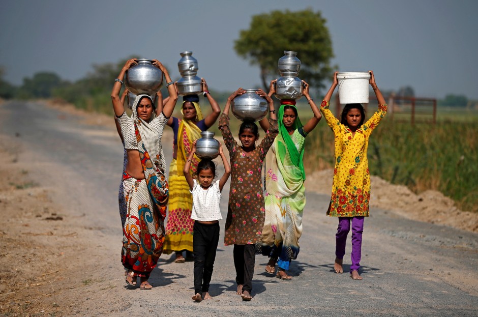 Women and girls carry water on the outskirts of Ahmedabad, India.