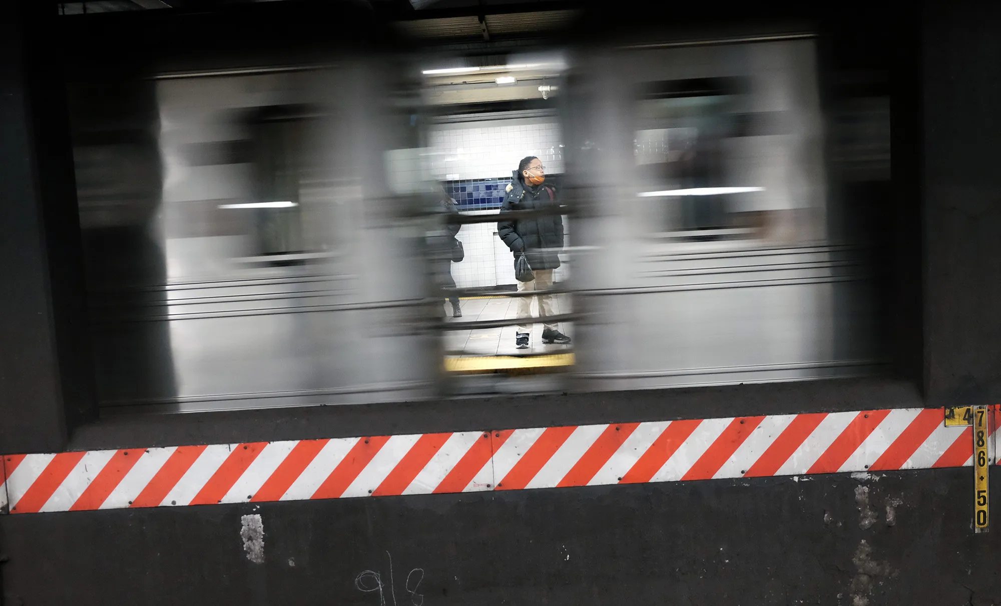 People wait for a train in a subway station in New York.&nbsp;
