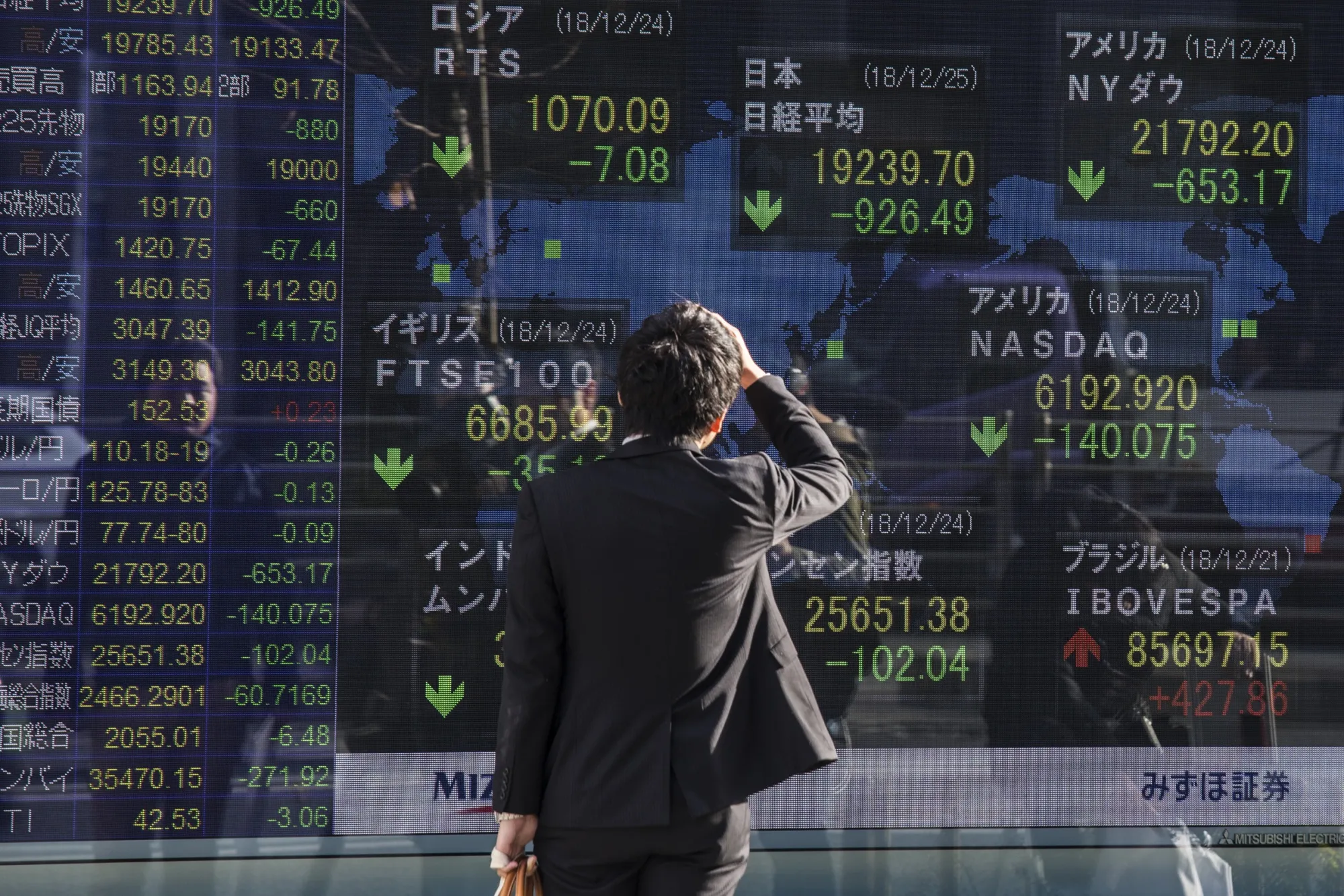 A man looks at a stock board in Tokyo on Dec. 25, 2018.