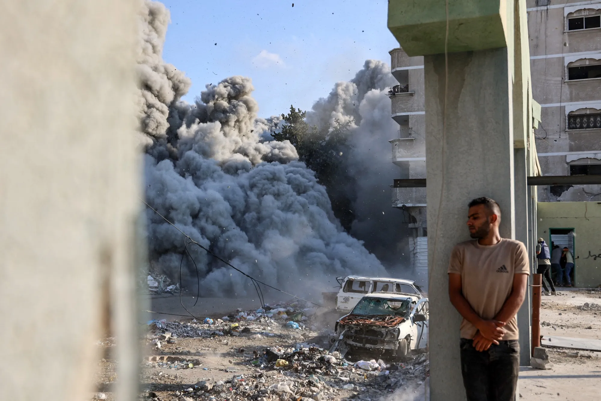 A man takes cover behind a column during an Israeli strike on the outskirts of Gaza City, on Sept. 1.