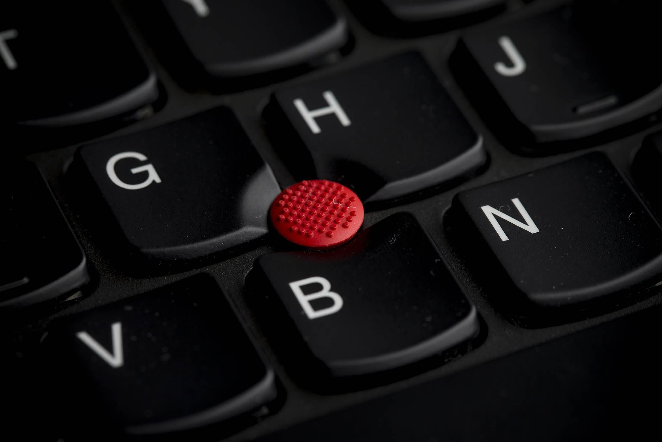 A Lenovo Group Ltd. trackpad button is displayed on a Lenovo ThinkPad T440s keyboard at the company's store in the Sha Tin district of Hong Kong, China, on Friday, Feb. 7, 2014. Lenovo, which has headquarters in Beijing and Morrisville, North Carolina, agreed to pay $2.3 billion for IBM’s low-end server unit on Jan. 23, adding a business with wider profit margins than PCs and giving it about 14 percent of the market.
