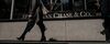 Pedestrians pass in front of a JPMorgan Chase & Co. office building in New York.