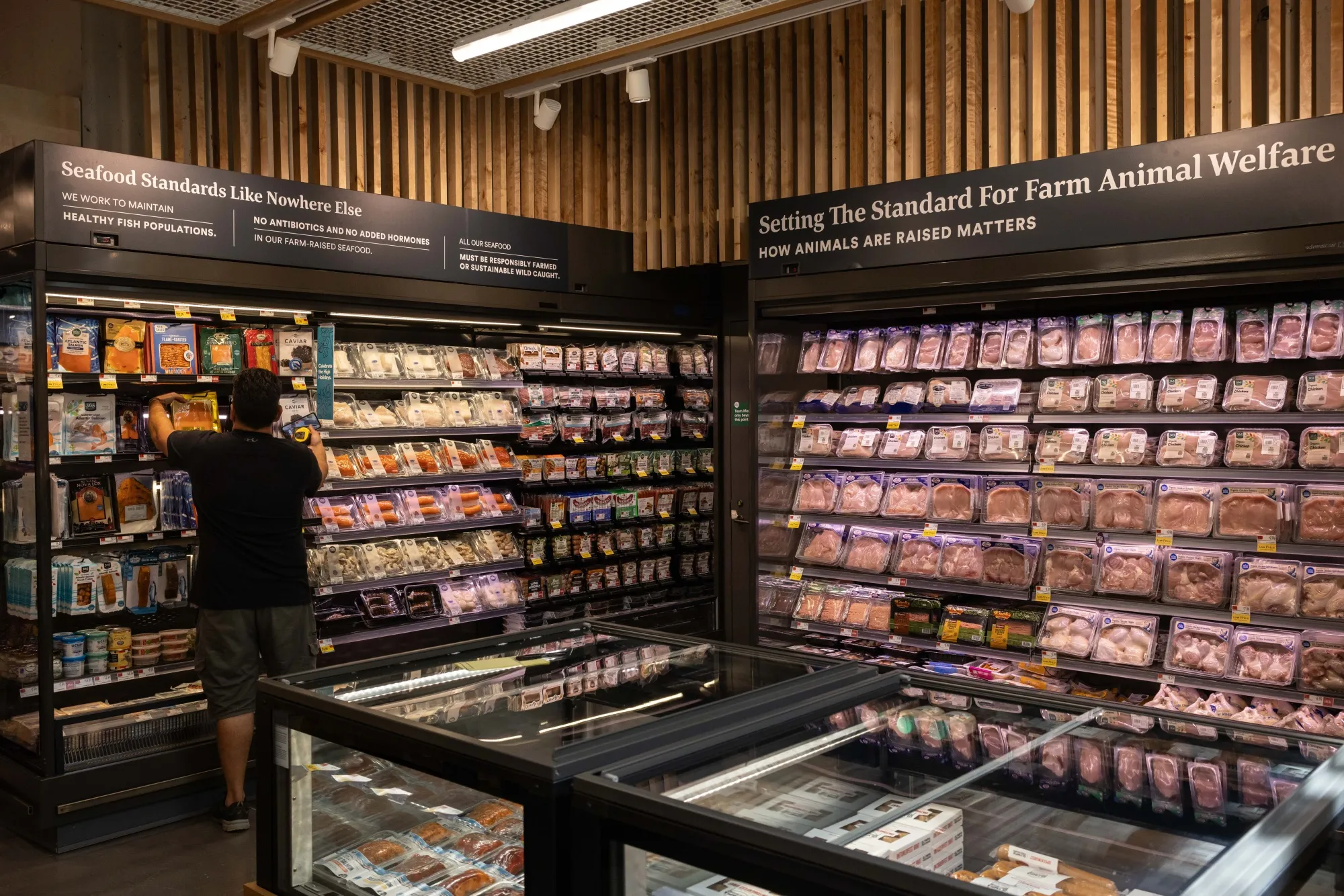 A worker prepares products at a Whole Foods Market Daily Shop in New York.