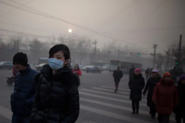 A woman wears a mask during severe pollution in Beijing on Jan. 12, 2013