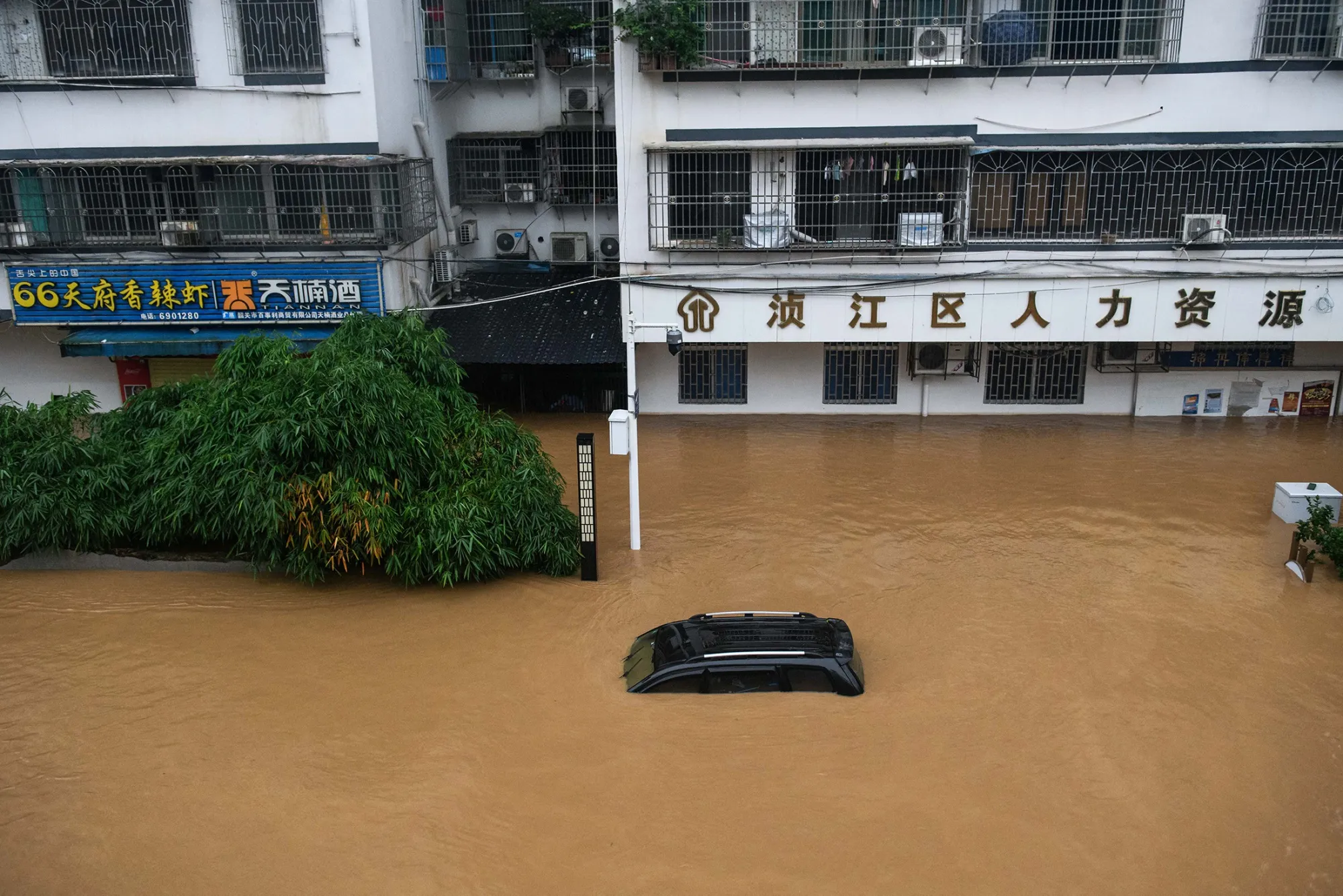 A submerged vehicle on a flooded street in Shaoguan on June 21.