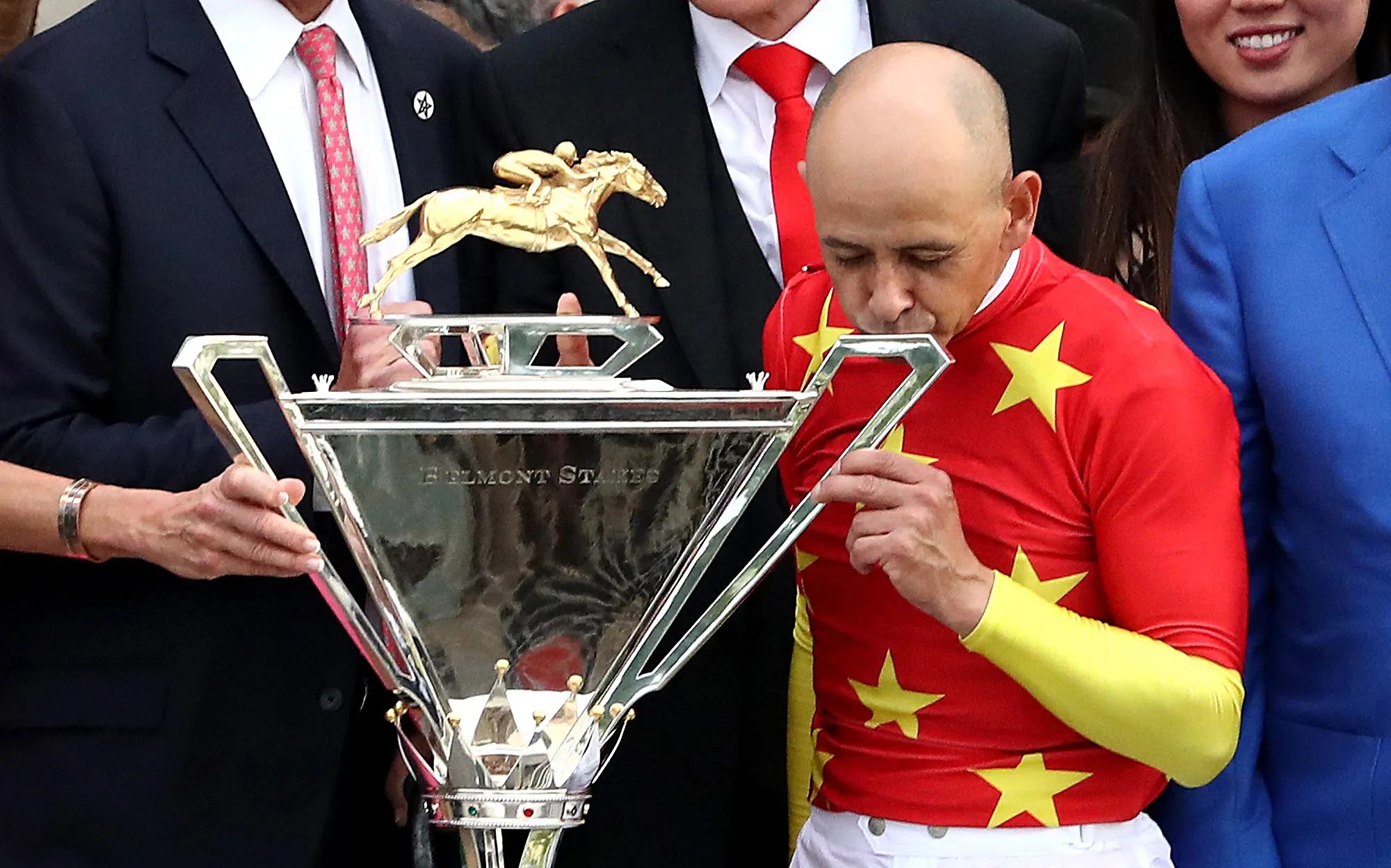 Mike Smith kisses the Triple Crown Trophy during the 150th running of the Belmont Stakes in Elmont, New York on June 9, 2018.