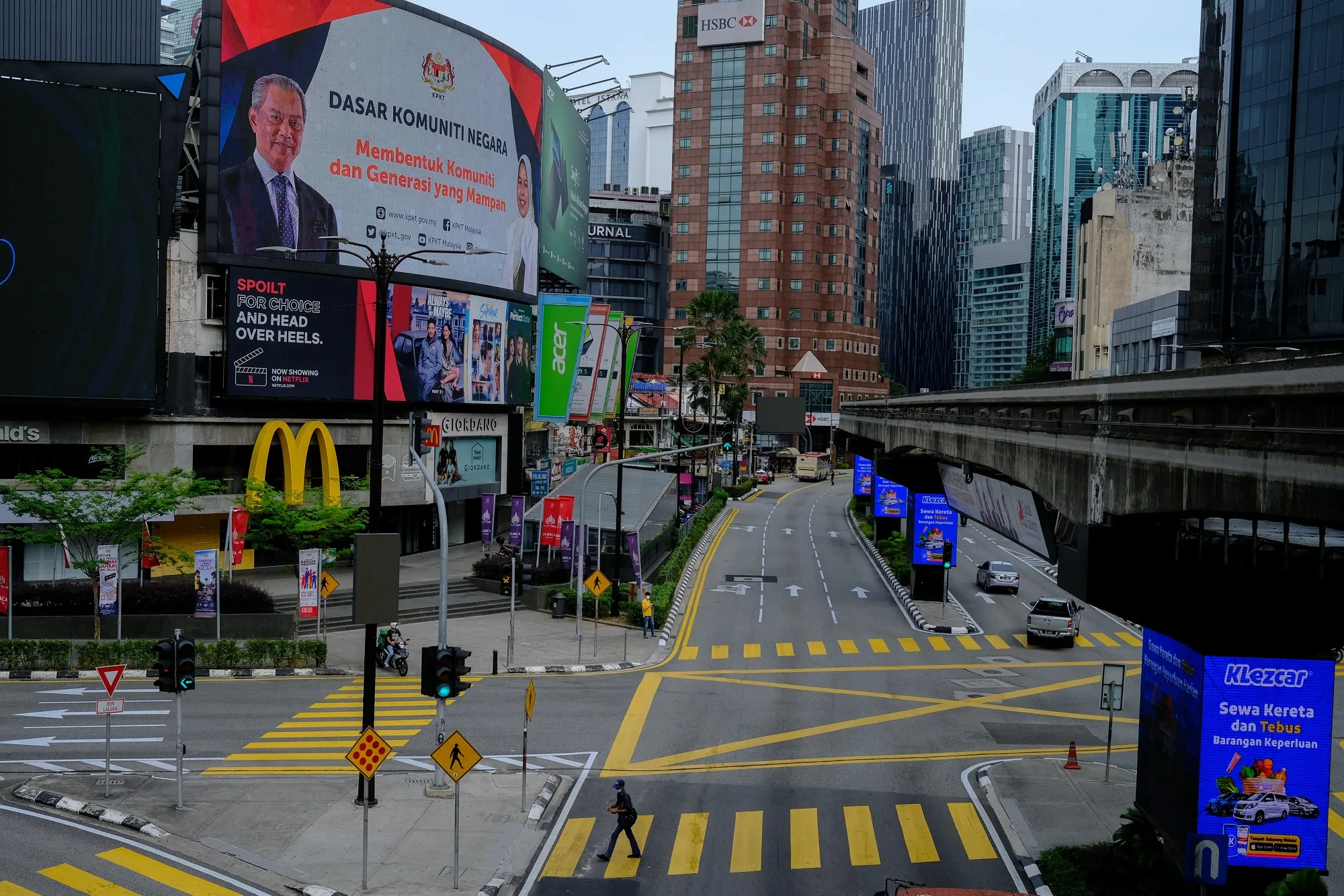 Vehicles travel along a near-empty road during a nationwide state of emergency in Kuala Lumpur, on Jan, 13.