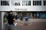 The WeWork logo sits on the company's co-working office space&nbsp;in Amsterdam, Netherlands.