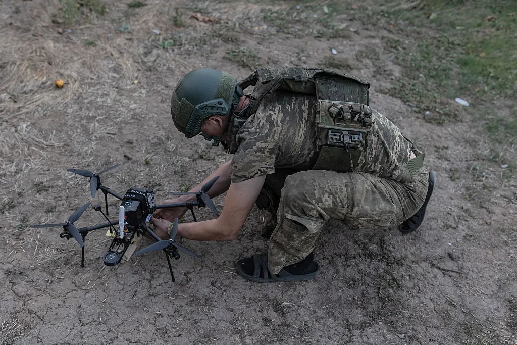 A Ukrainian soldier prepares a drone to attack Russian positions.