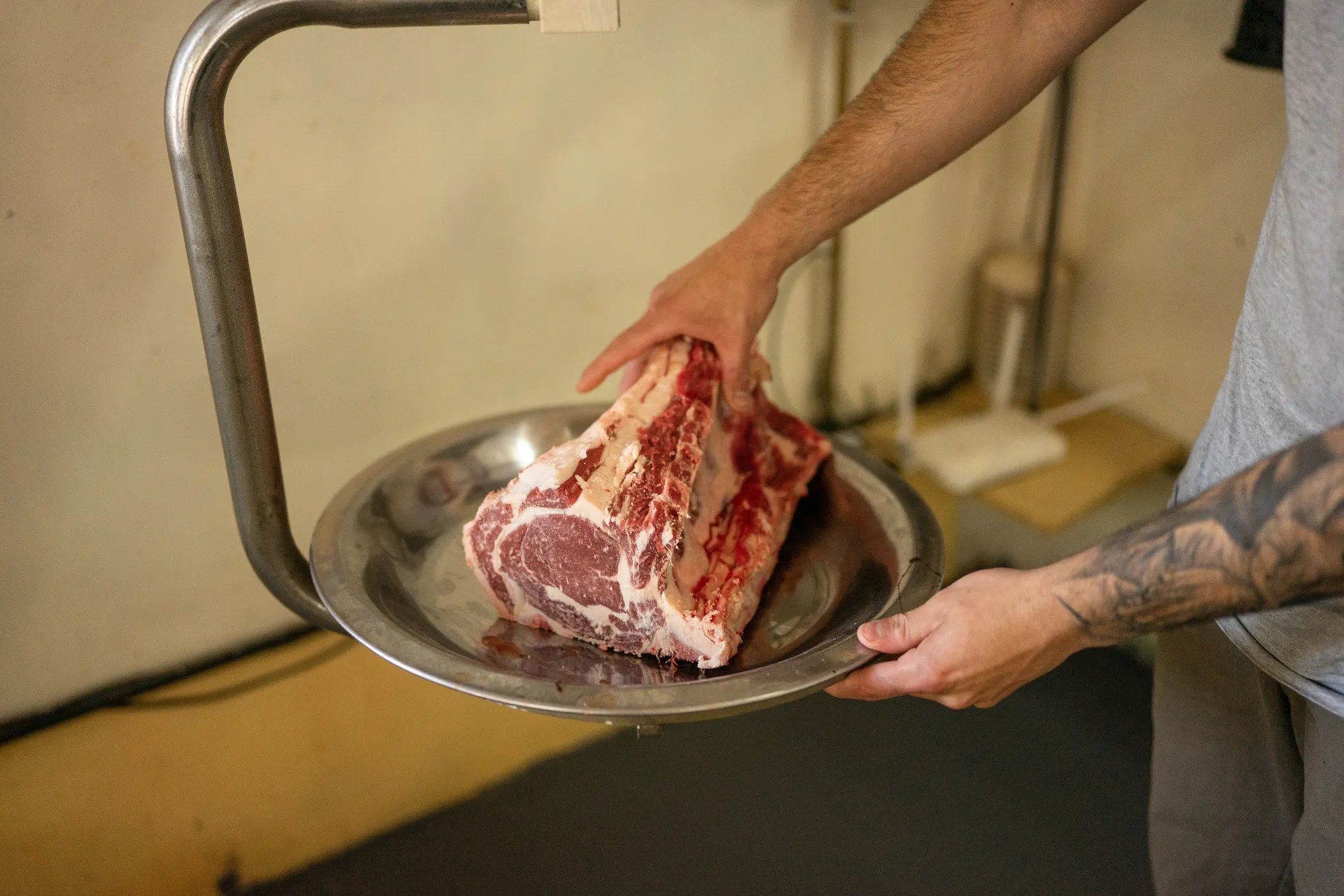 A worker weighs a cut of beef at a butcher shop in Rosario, Argentina, in 2025.