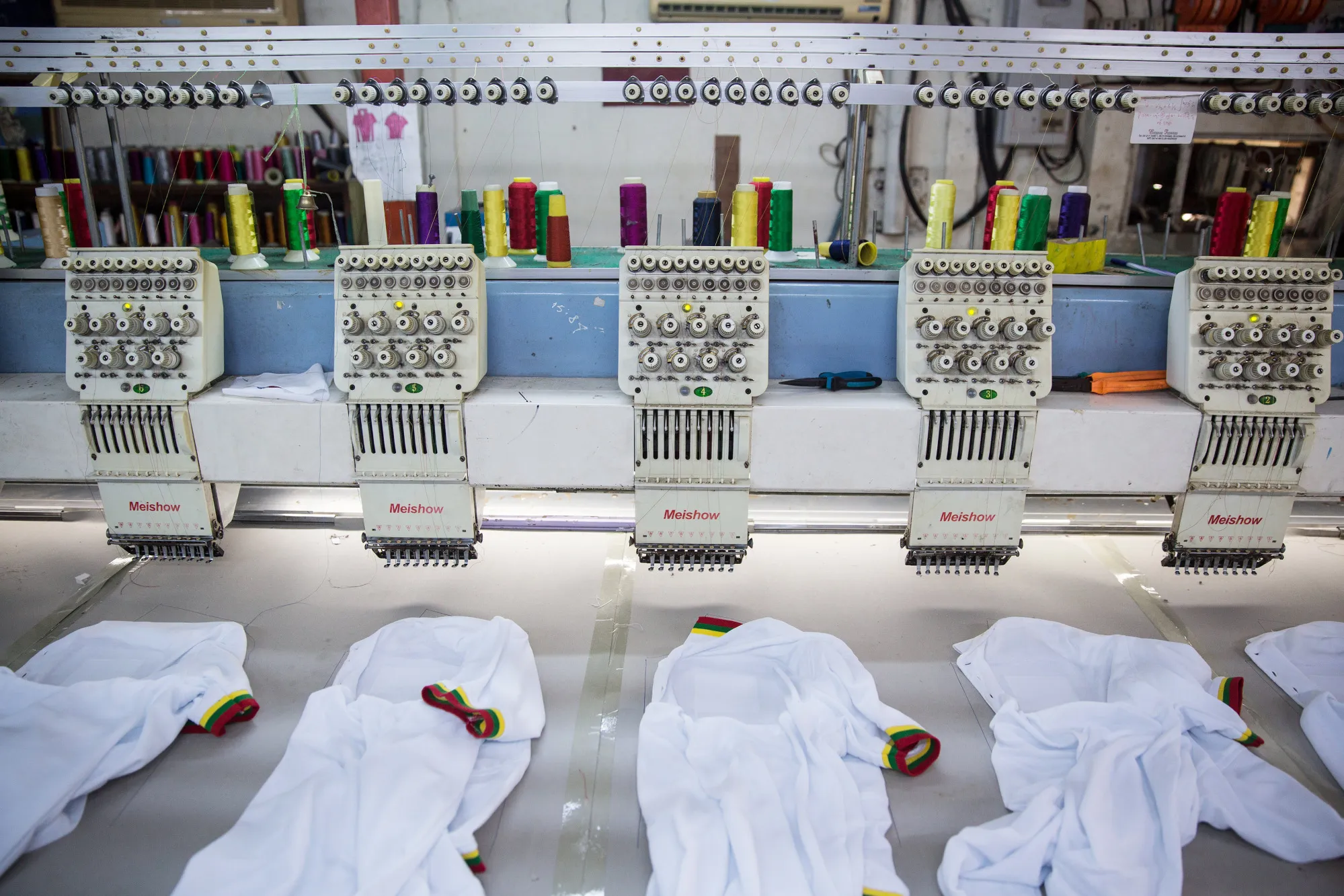 Shirts sit at a textile embroidery machine at a factory in Yangon, Myanmar in&nbsp;2018.&nbsp;