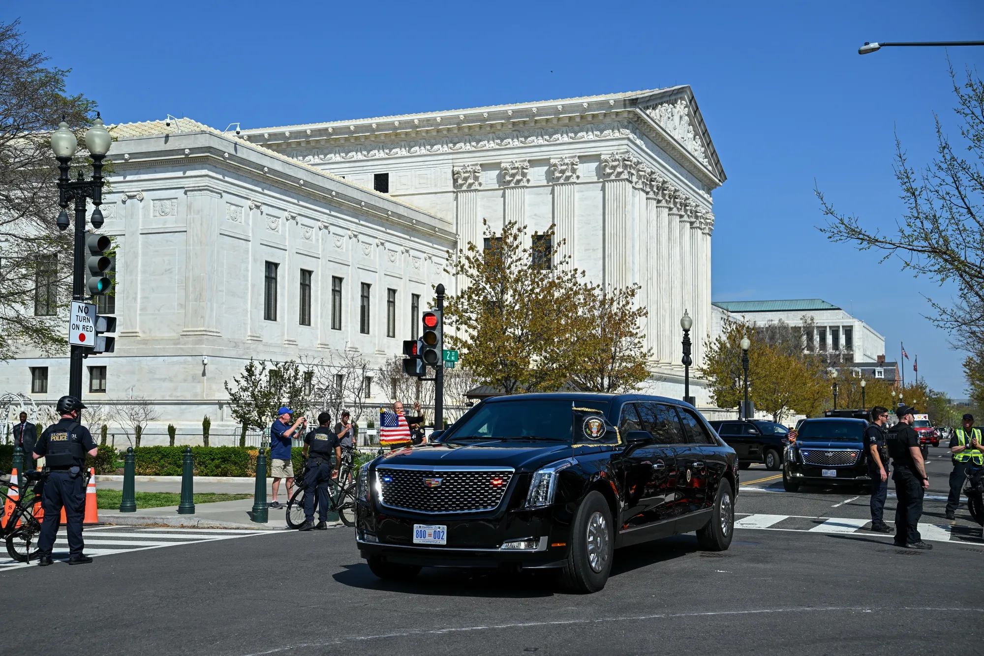 A motorcade carrying President Donald Trump departs the Supreme Court today.