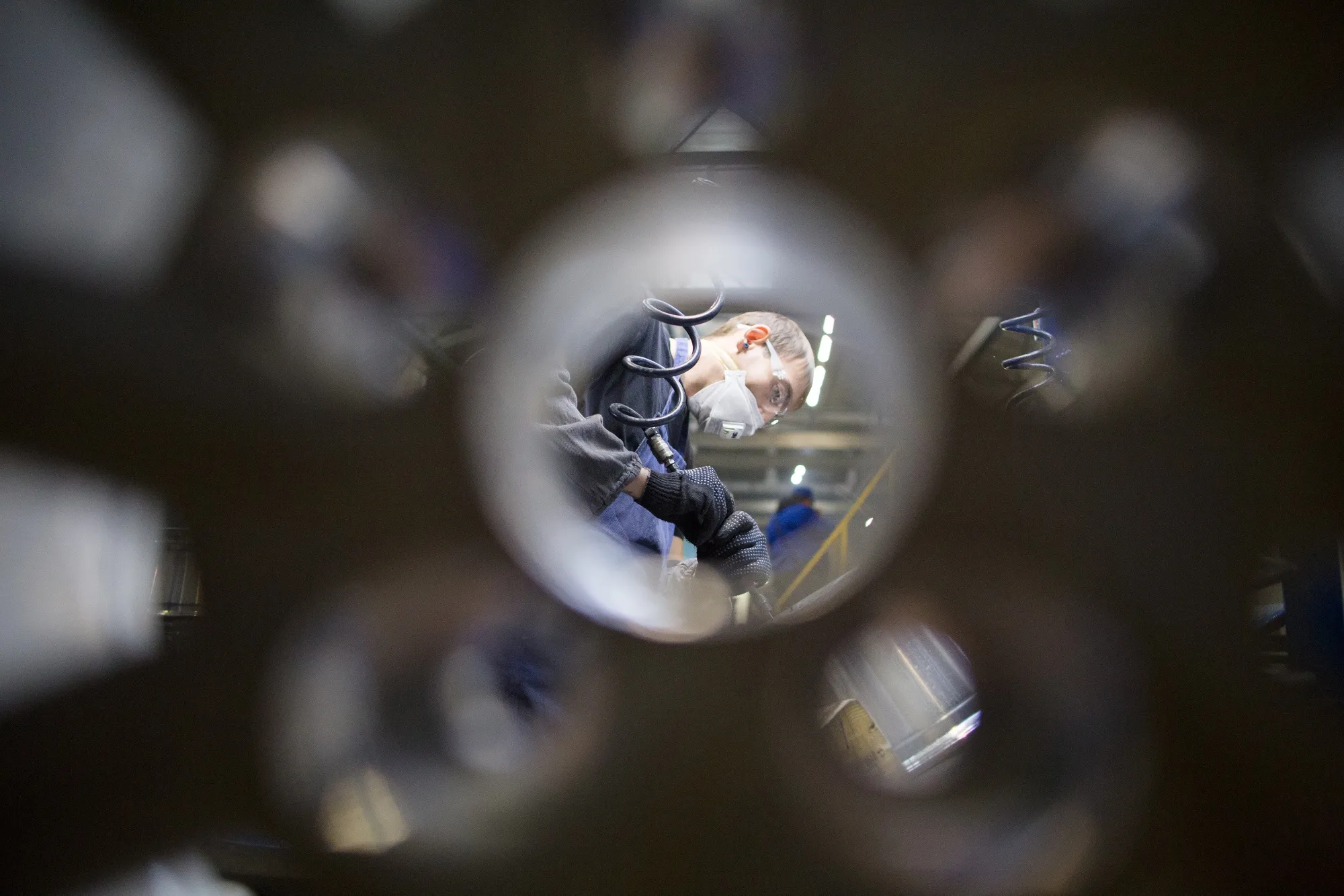 A worker uses a polishing machine to finish wheels at the Casting And Mechanical Plant in Divnogorsk, Russia.