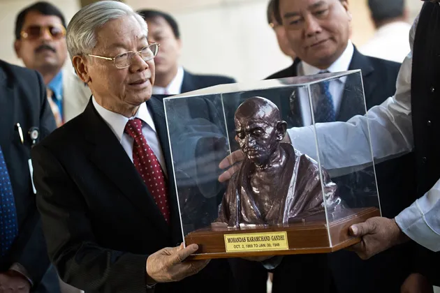 General Secretary of the Communist Party of Vietnam Nguyen Phu Trong receives a gift during his visit to the Mahatama Gandhi memorial in New Delhi, on Nov. 20