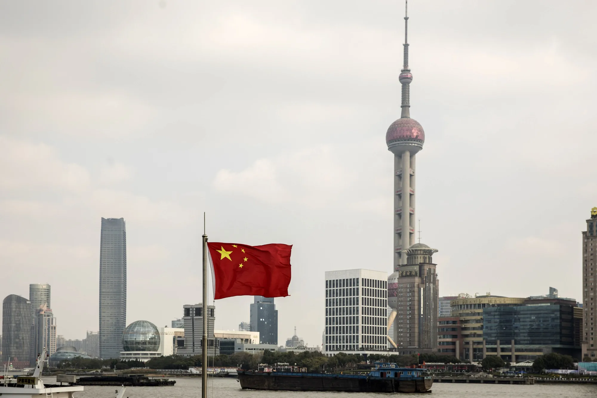 The Pudong Lujiazui Financial District stand across the Huangpu River in Shanghai, China.
