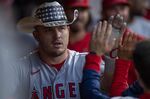 Los Angeles Angels' Mike Trout celebrates in the dugout after hitting a two-run home run off Cleveland Guardians starting pitcher Konnor Pilkington during the fifth inning of a baseball game, Monday, Sept. 12, 2022, in Cleveland. (AP Photo/David Dermer)