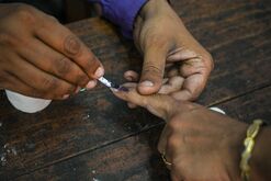 A voter's finger is marked with indelible ink at a polling station in Kanpur, Uttar Pradesh, India.