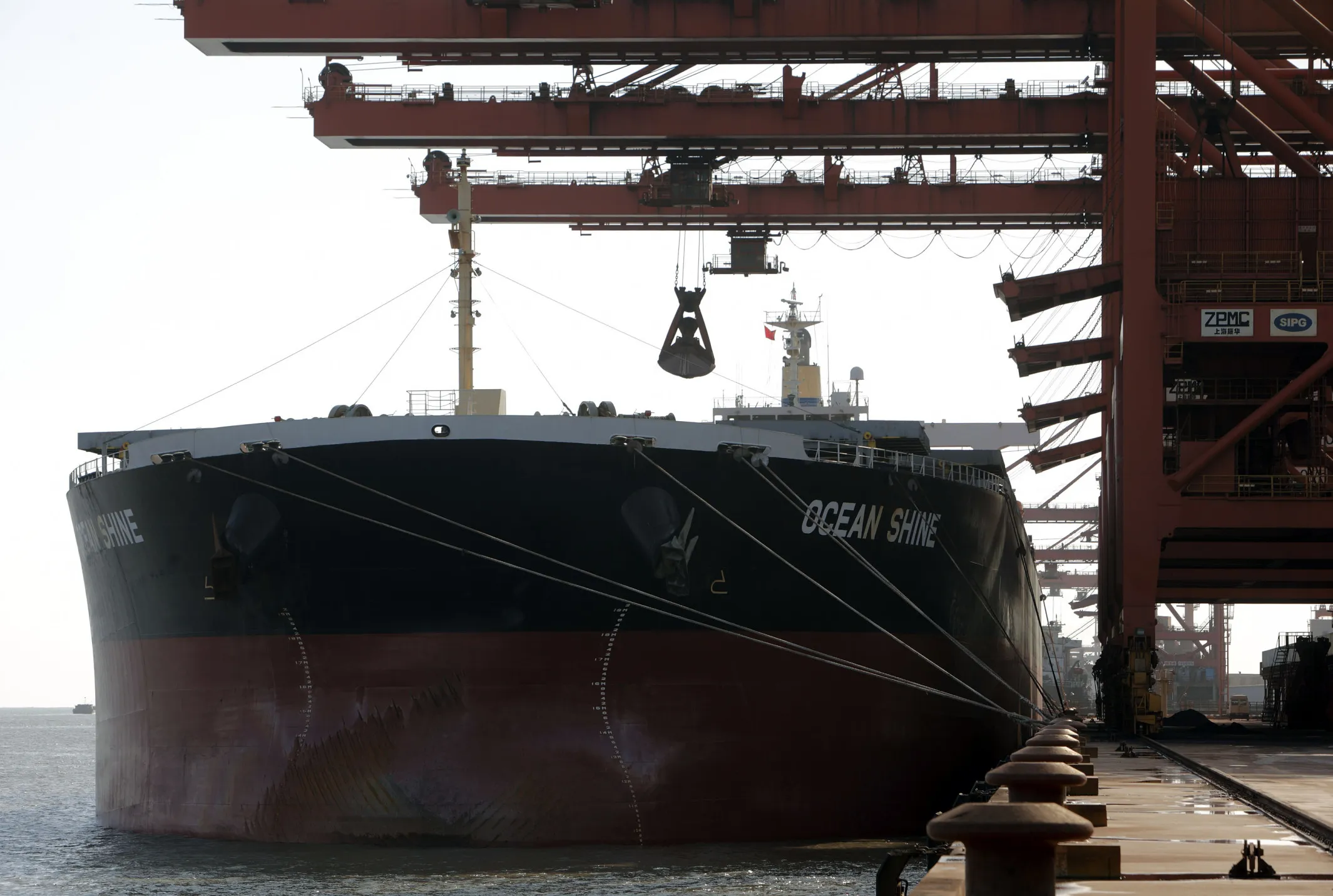 A bulk carrier cargo ship docks at an iron ore transfer center in Shanghai, China.