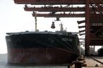 A bulk carrier cargo ship docks at an iron ore transfer center in Shanghai, China.