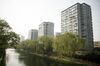 Residential buildings and willow trees stand along a canal in the Yonghegong area of Beijing, China, on Monday, April 16, 2018. New home prices in Beijing and Shanghai have jump more than 25 percent over the last two years.