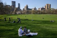 People enjoy the warm weather at Central Park in New York.