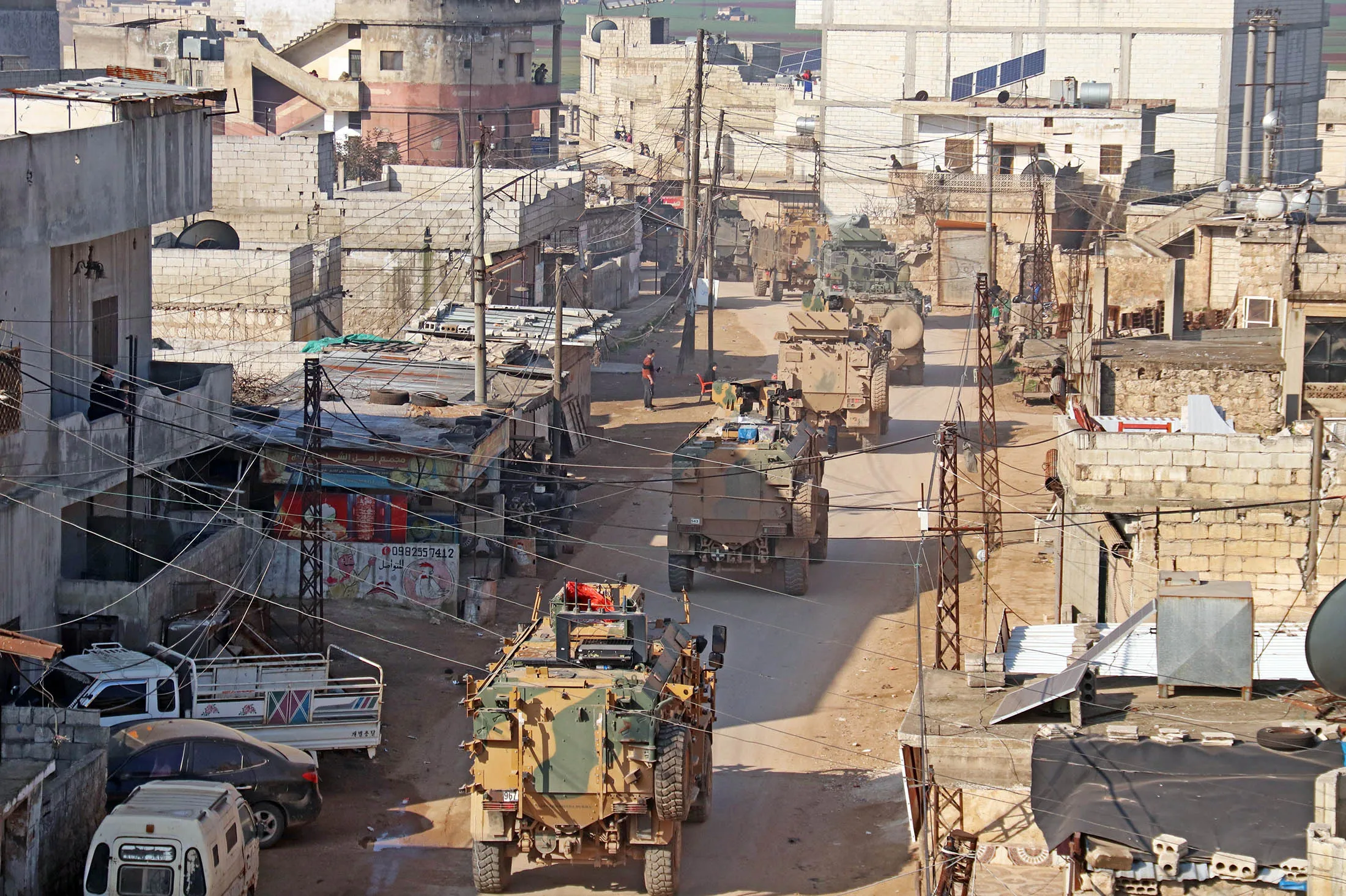 A Turkish military convoy passes through a village near Idlib, Syria, on Feb. 25.