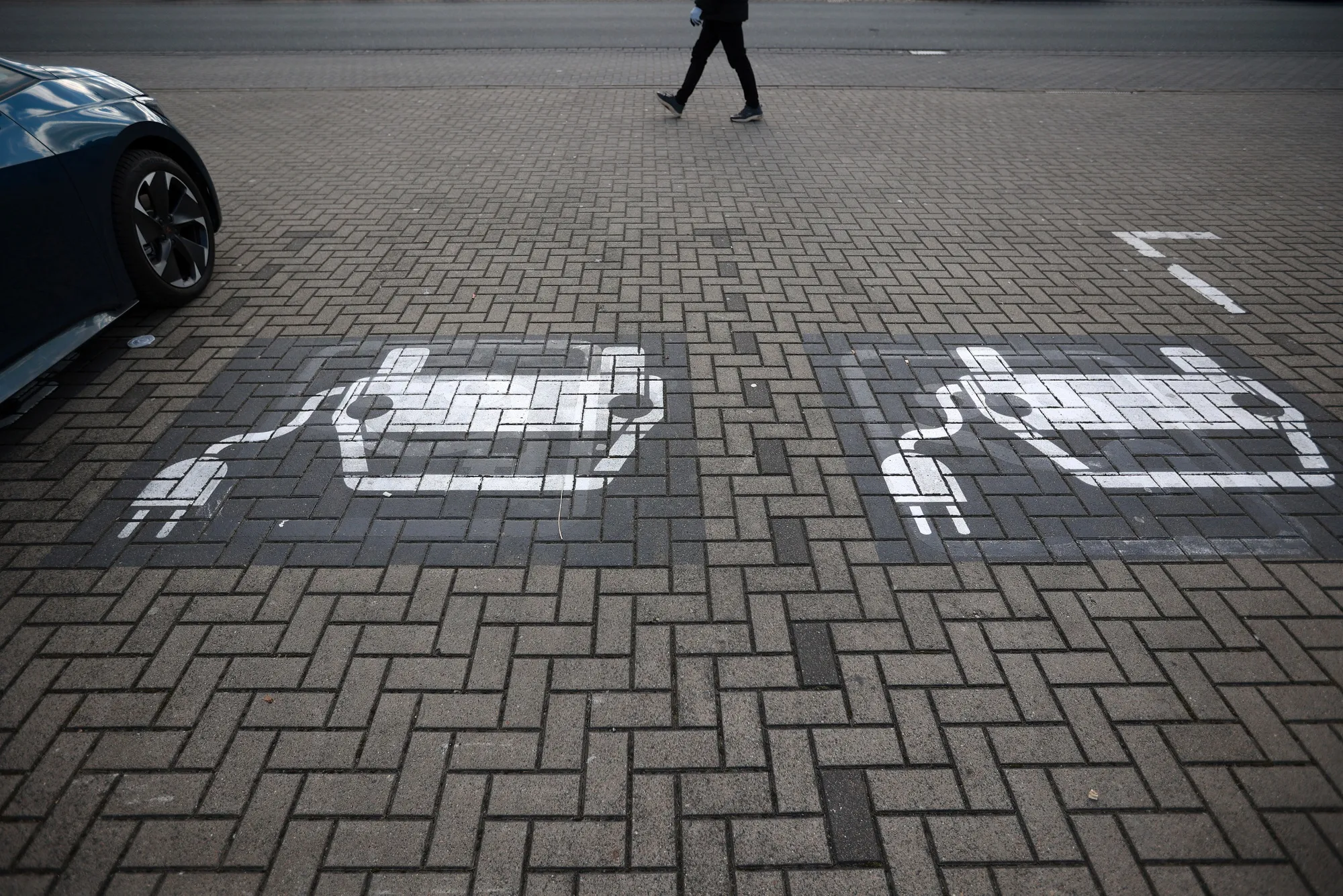 Electric vehicle (EV) charging stations in the parking lot of a train station in Wolfsburg, Germany.