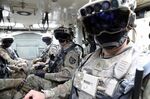 Soldiers don IVAS hardware&nbsp;while mounted in a Stryker in Joint Base Lewis-McCord, Washington.