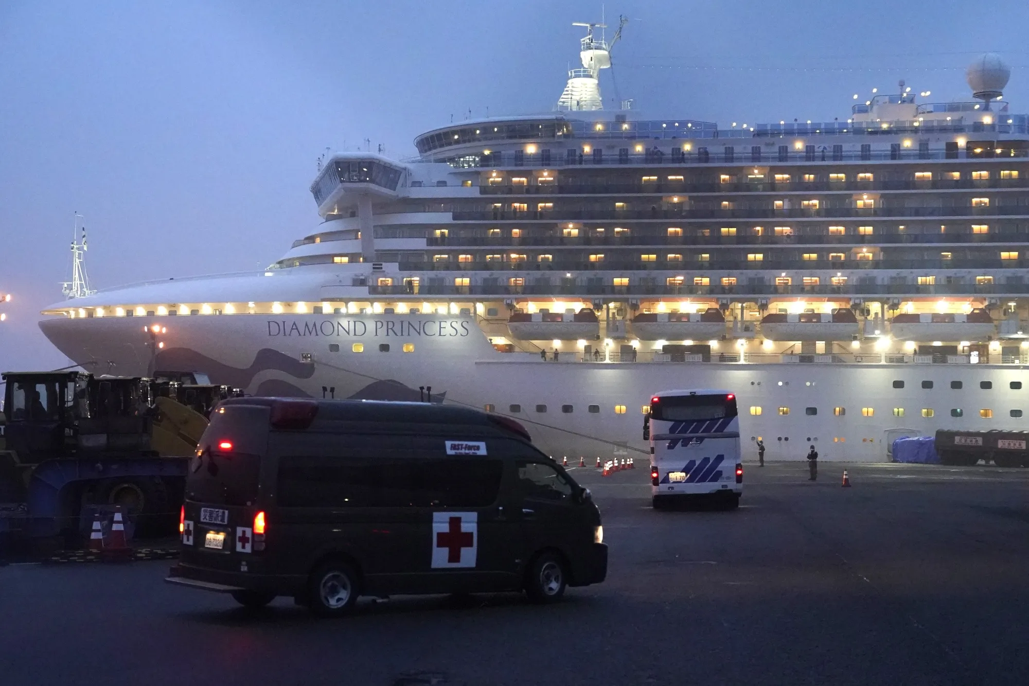 A coach and an ambulance travel towards the Diamond Princess cruise ship in Yokohama, on Feb. 16.
