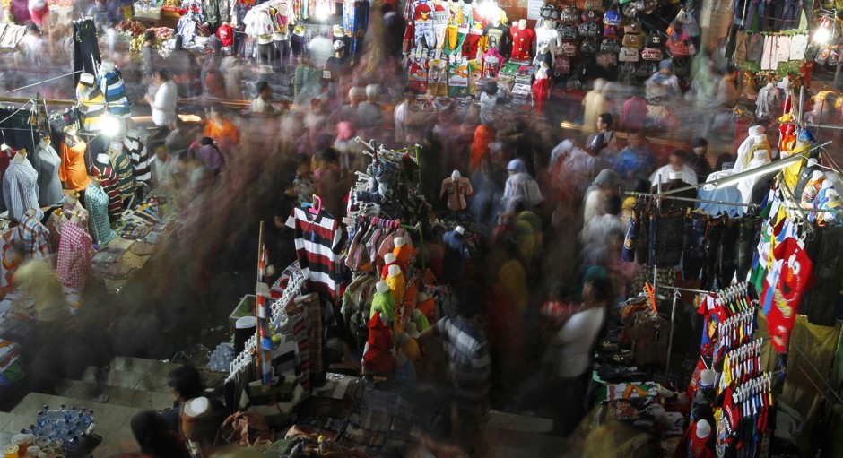 Shoppers walk through the central textile market to buy new clothes in downtown Jakarta.