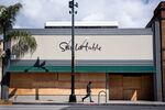 A man passes a boarded up Sur La Table in Pasadena, California on March 23. 