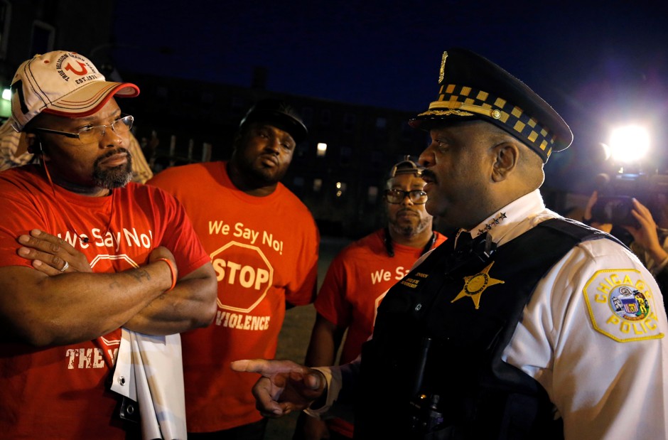 Chicago Police Superintendent Eddie Johnson (right) speaks to anti-violence advocates about patrolling a neighborhood while wearing a body camera in Chicago, Illinois.
