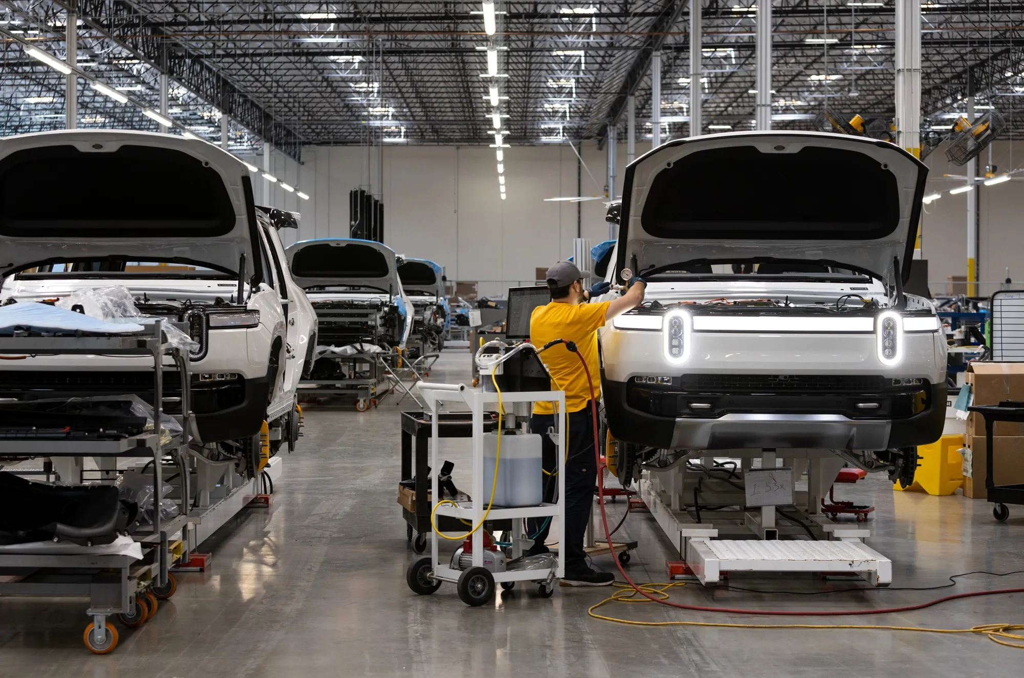 An employee works on an R1S model electric vehicle on the pilot production line at Rivian's headquarters in Irvine, California,&nbsp;on July 5.