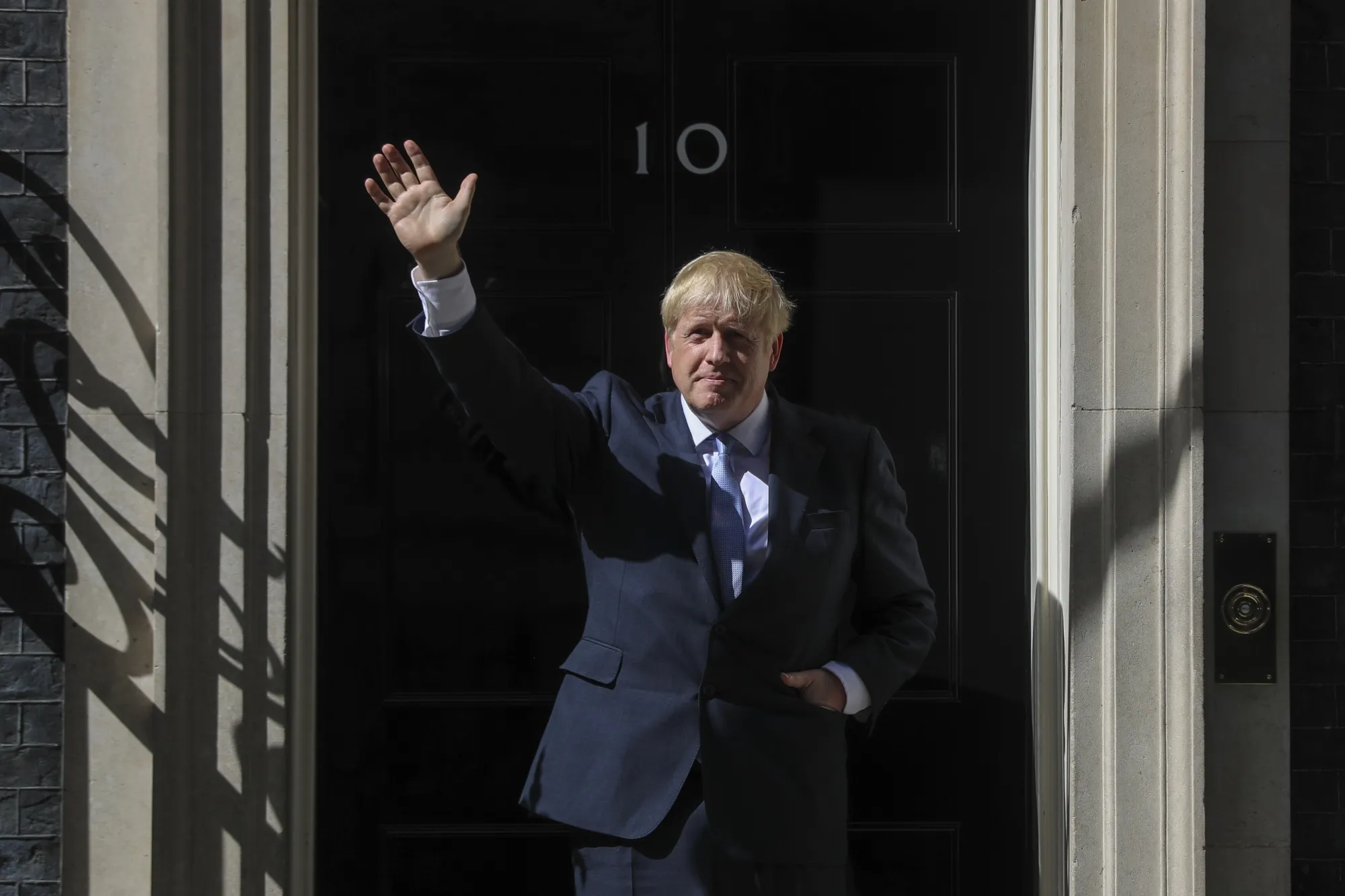 Boris Johnson, U.K. prime minister, waves as he enters number 10 Downing Street in London on July 24, 2019.&nbsp;