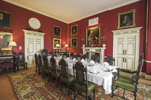 Here, the dining room. Those 19th century Jacobean dining chairs are for sale, too, in a set of 16.