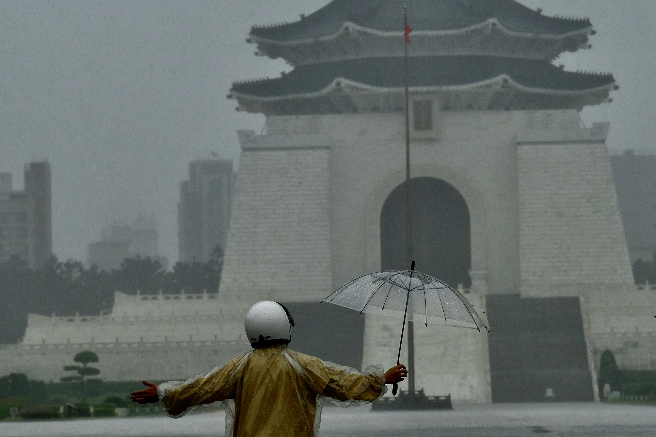 A man stands in heavy rain&nbsp;in Taipei on June 4.