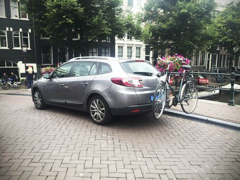 An UberBike car picks up a passenger (and wheels) in Amsterdam's canal zone