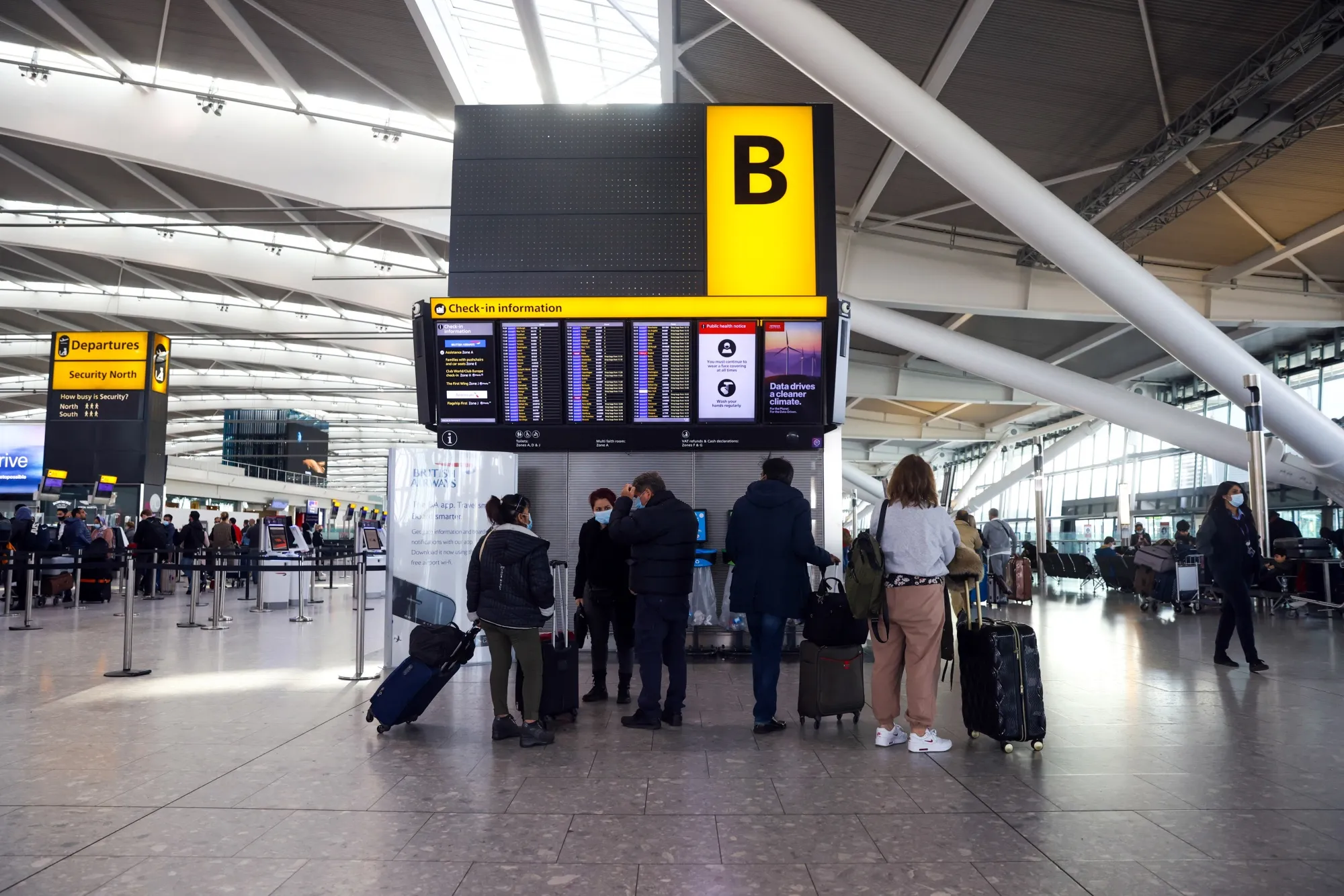 Travelers at Terminal 5 at London Heathrow Airport.