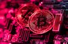 Two coins representing Bitcoin cryptocurrency sit on a computer circuit board in this arranged photograph in London, U.K., on Tuesday, Feb. 6, 2018. Cryptocurrencies tracked by Coinmarketcap.com have lost more than $500 billion of market value since early January as governments clamped down, credit-card issuers halted purchases and investors grew increasingly concerned that last year’s meteoric rise in digital assets was unjustified.