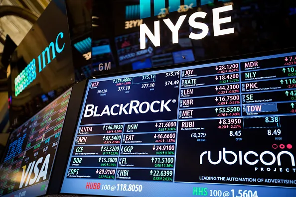 A monitor displays BlackRock Inc. signage on the floor of the New York Stock Exchange (NYSE) in New York, U.S., on Tuesday, Jan. 17, 2017. U.S. stocks fell as markets reopened after Monday's holiday as financial and health-care shares declined and the U.S. dollar headed for the biggest single-day loss since July.
