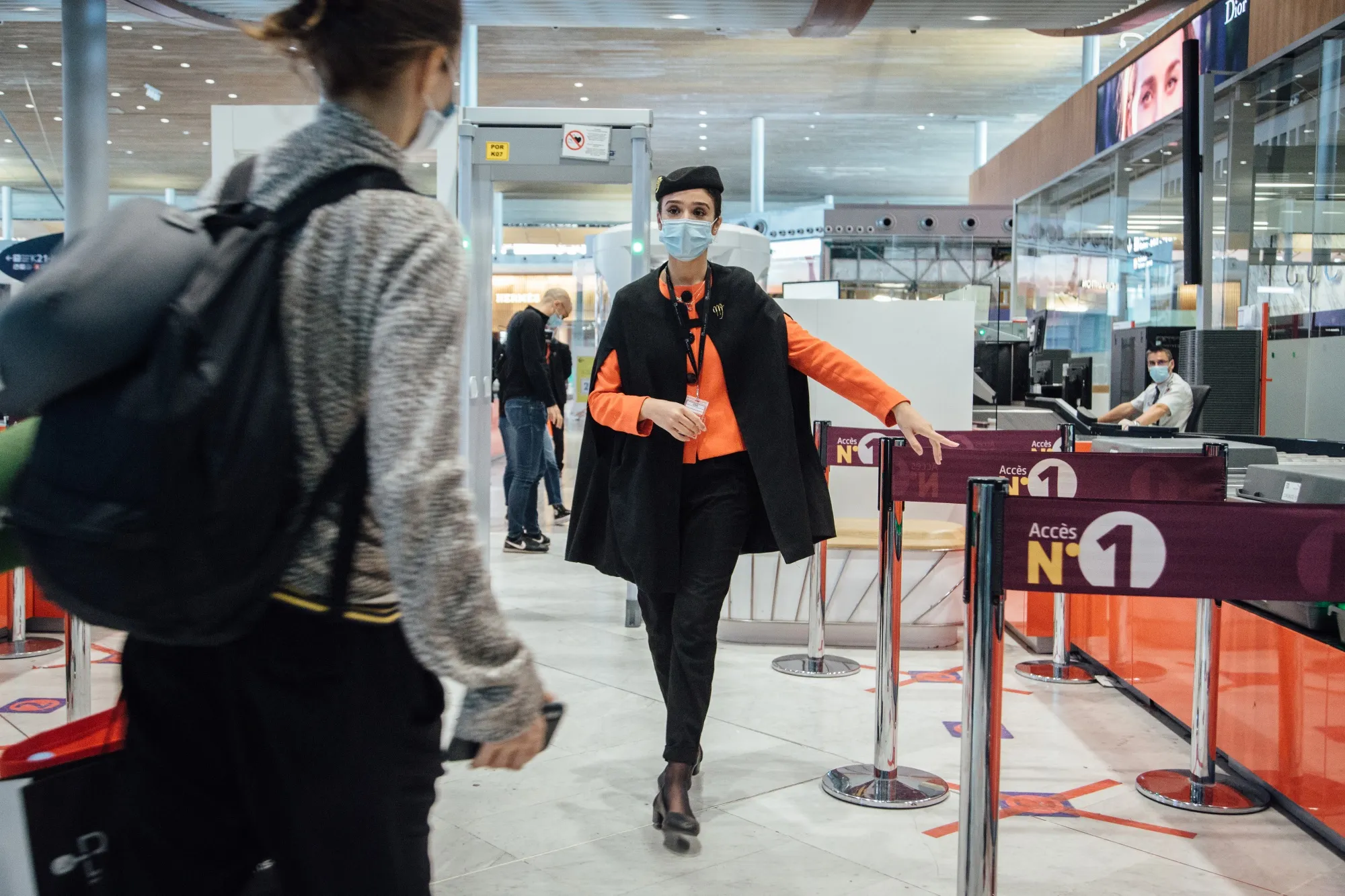 A worker&nbsp;directs travelers at the Air France-KLM baggage drop-off area at Charles de Gaulle Airport, near Paris in May.