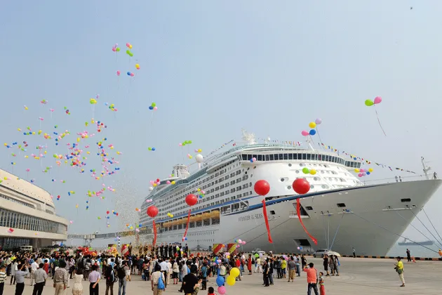 People hail the arrival of Asia's largest luxury cruise liner, Voyager of the Seas, in Tianjin, China, in 2012